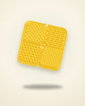 Yellow silicone lick mat with four textured sections