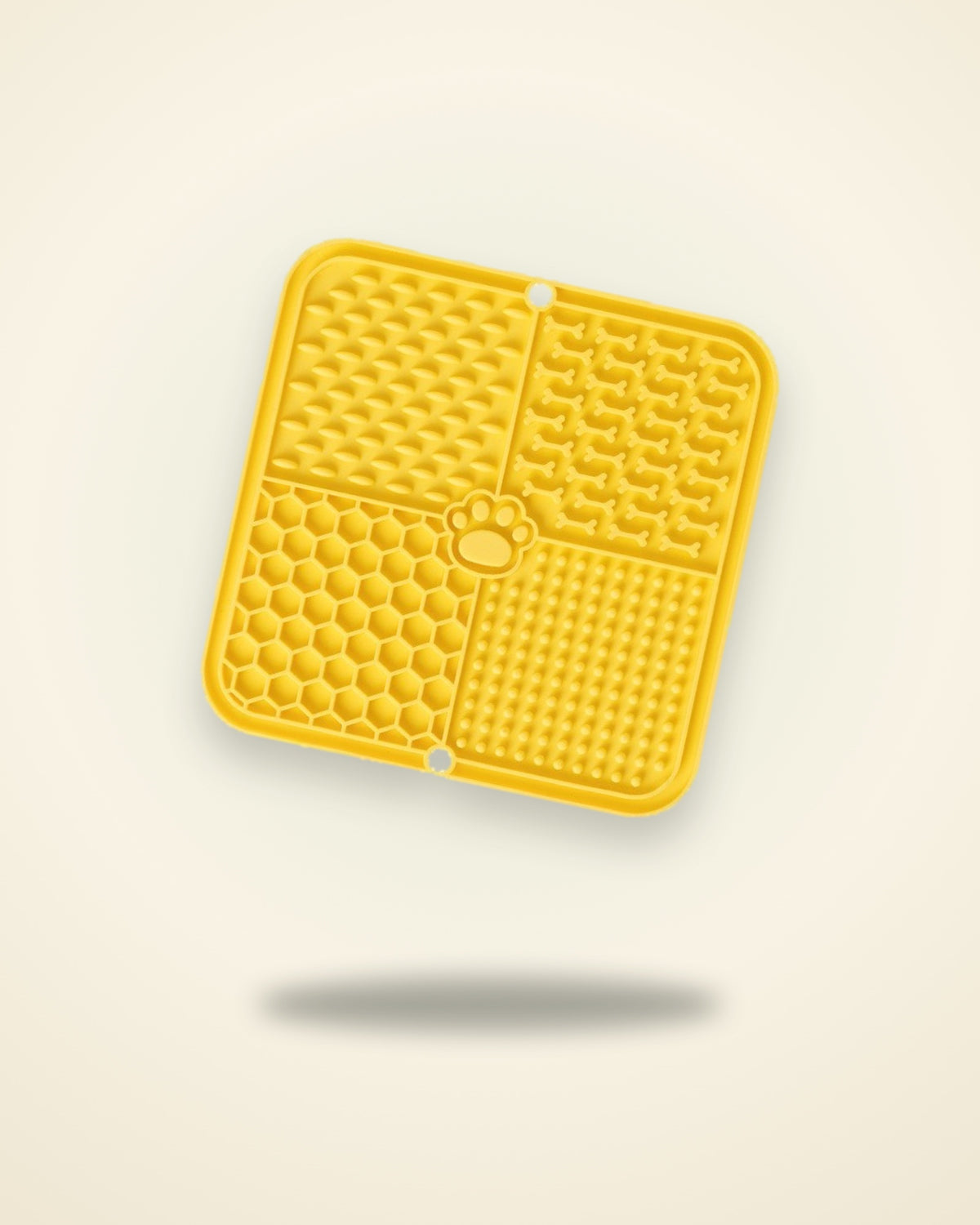 Yellow silicone lick mat with four textured sections